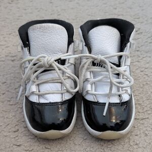 Jordan 11s Kids Black & White Patent Toe Sneakers